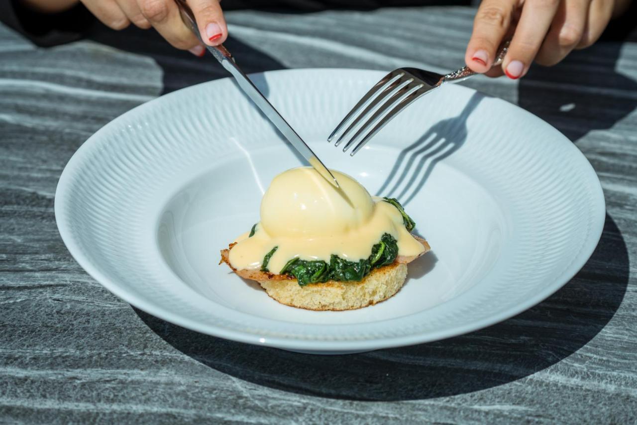 El Llorenc Parc De La Mar - Adults Only Palma de Mallorca Dış mekan fotoğraf A poached egg being cut with a knife and fork